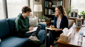 Teen boy and therapist in relaxed CBT session