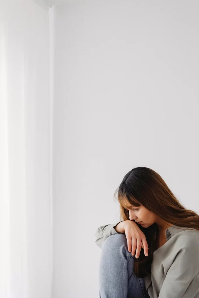Woman reflecting during a session with her therapist in Oakland at Revive Health Therapy