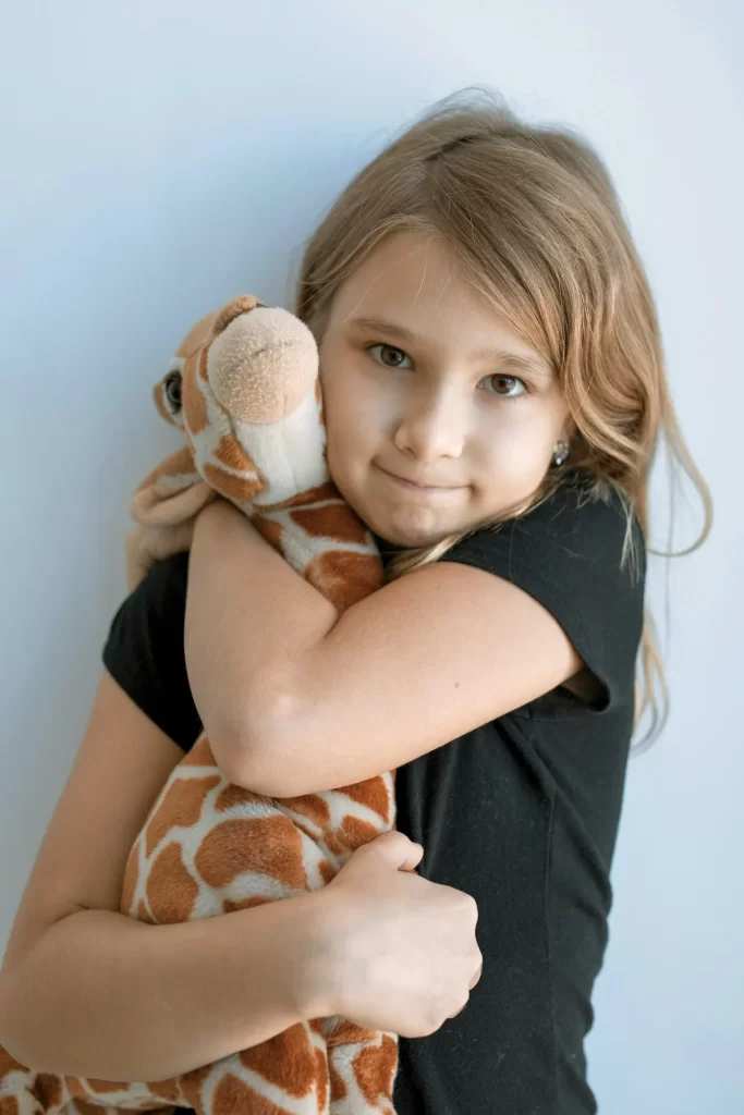 Girl at children's therapy at Revive Health Therapy with her stuffie.