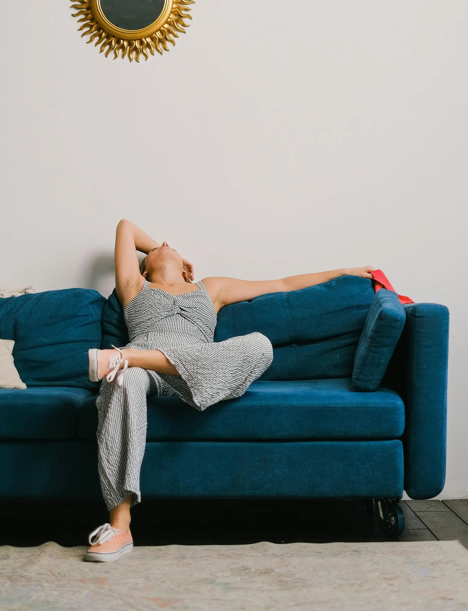 Candid photo of a woman sitting on her couch after a Telehealth therapy session