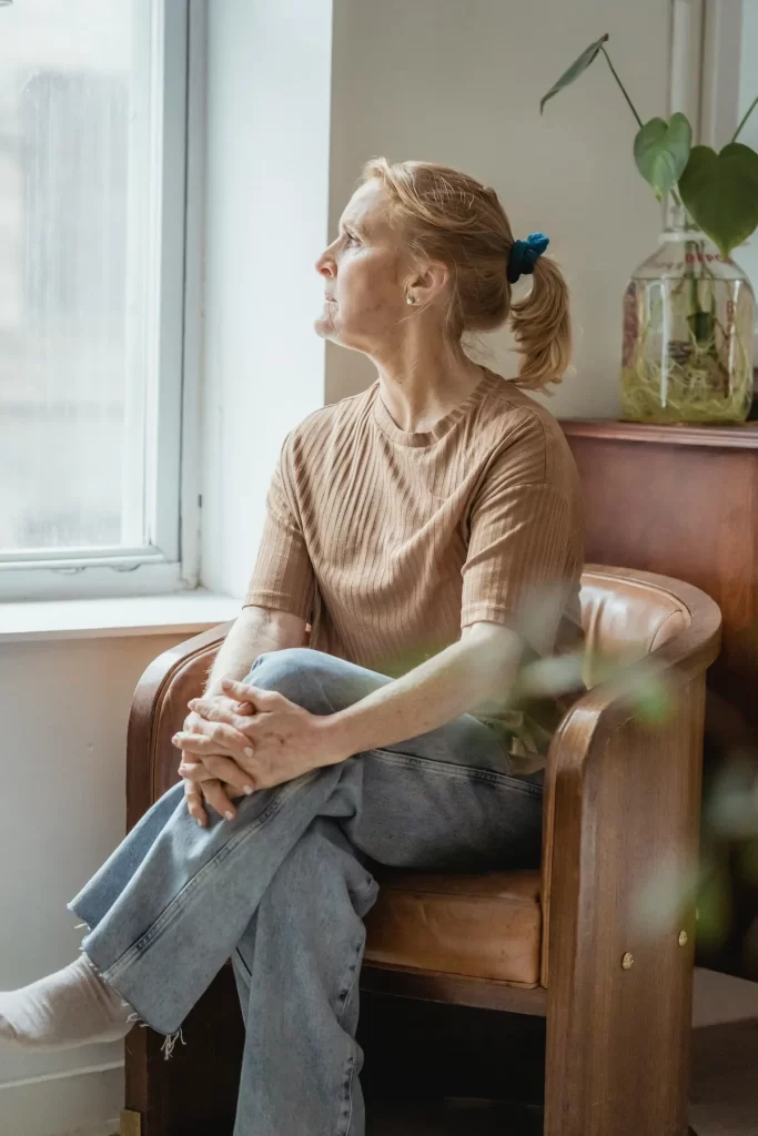 Person looking out the window and dealing with gried