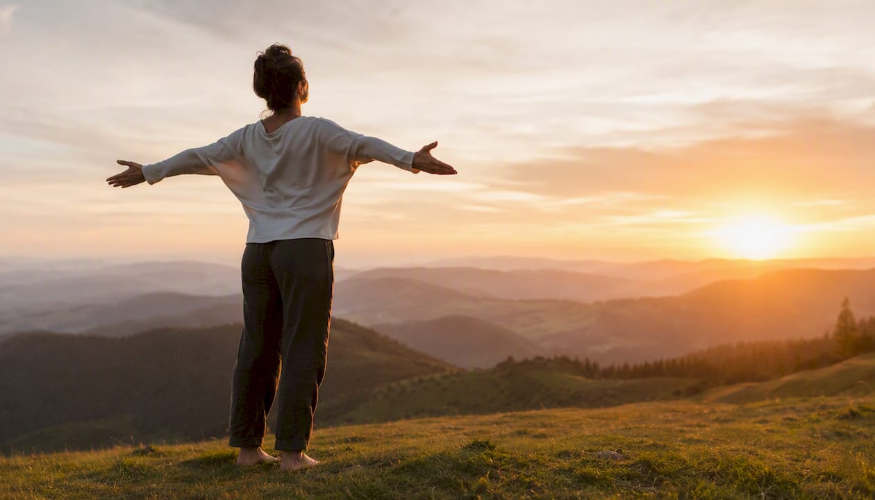 Person breathing deeply by lake