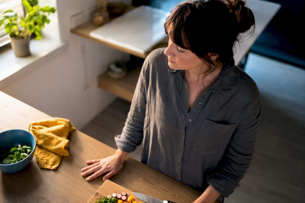 Adult pausing during cooking after intrusive thought
