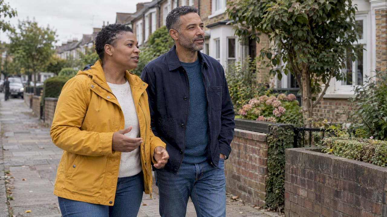 Couple walking together on a neighborhood path