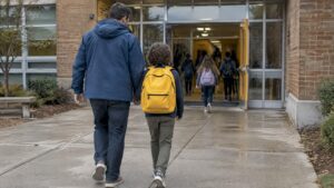 Parent and child approach a school entrance